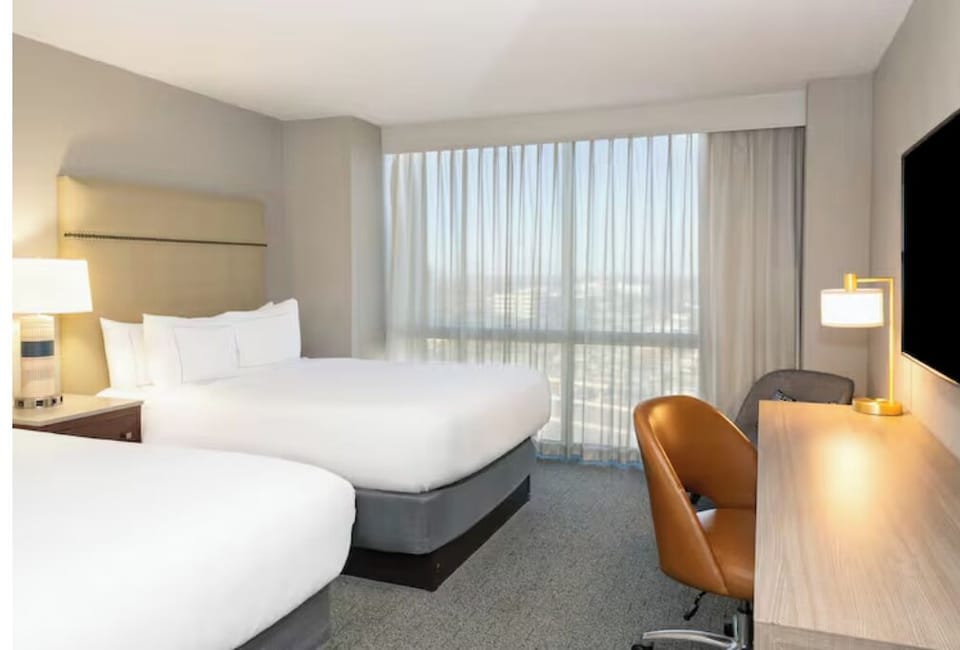 Spread out comfortably with two beds and a bright workspace.