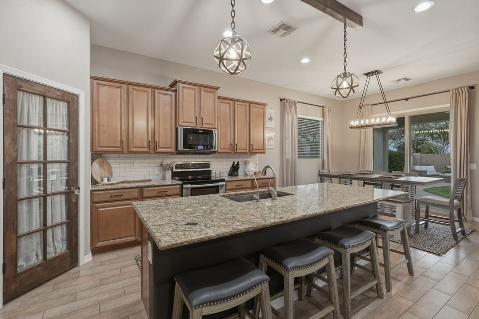 A full kitchen with stainless steel appliances.