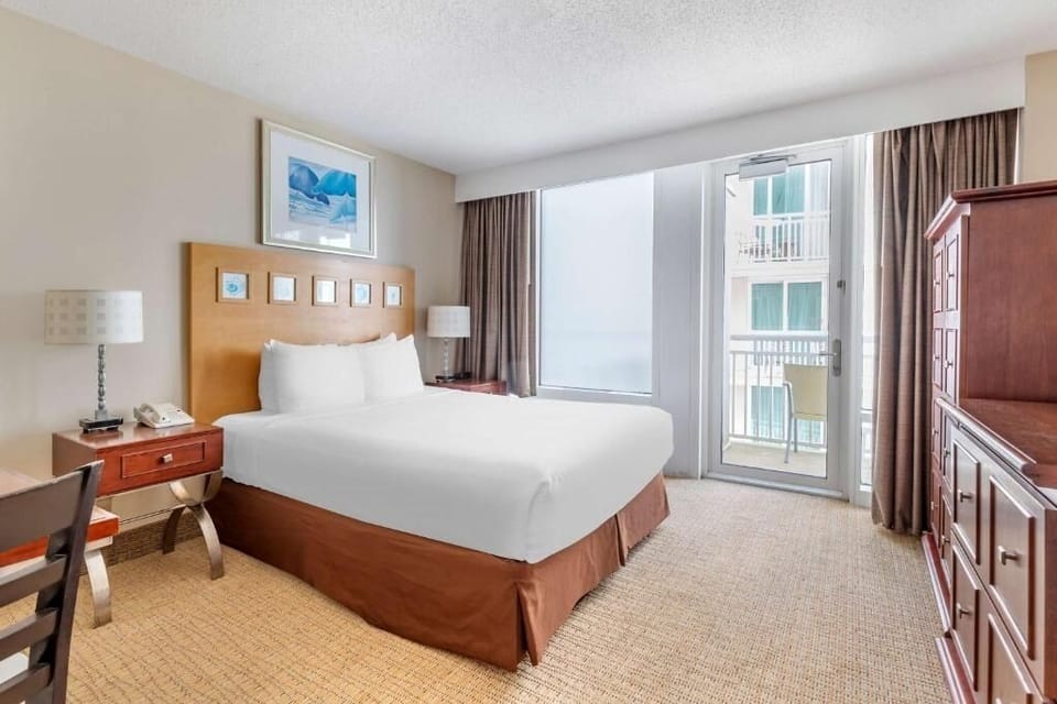 Wake up to ocean air with balcony steps from bed.