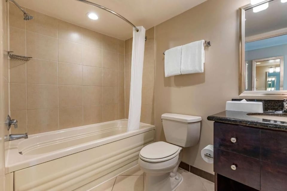 Refresh effortlessly with a clean tub shower and bright vanity.