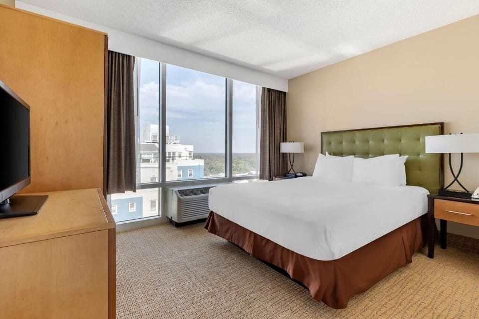 Sink into crisp linens and enjoy panoramic skyline views.