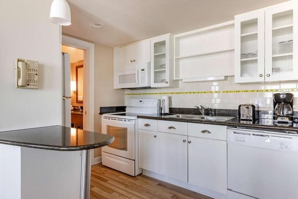 Cook and sip coffee easily in the bright, stocked kitchen.