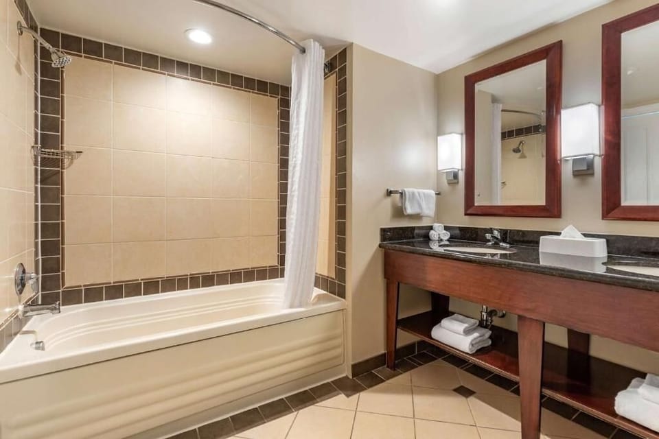 Relax into a warm bath beneath bright, spa-like lighting.