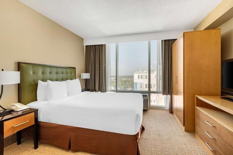 Unwind in crisp linens with bright skyline views.