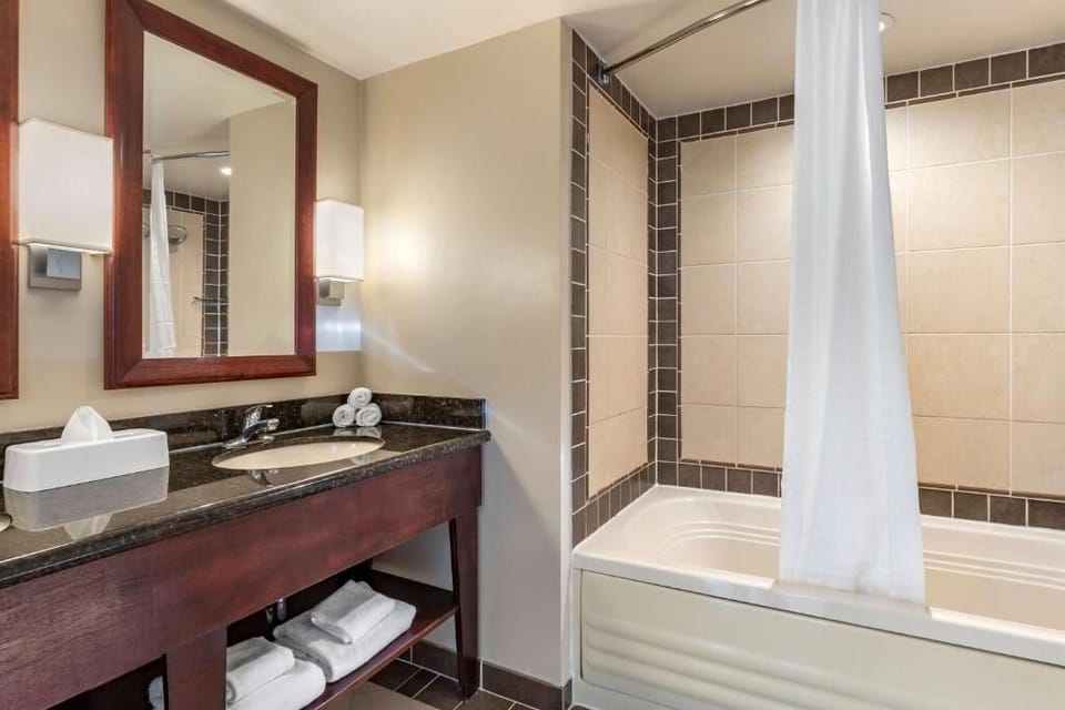 Pamper yourself with plush towels and a spacious vanity setup.