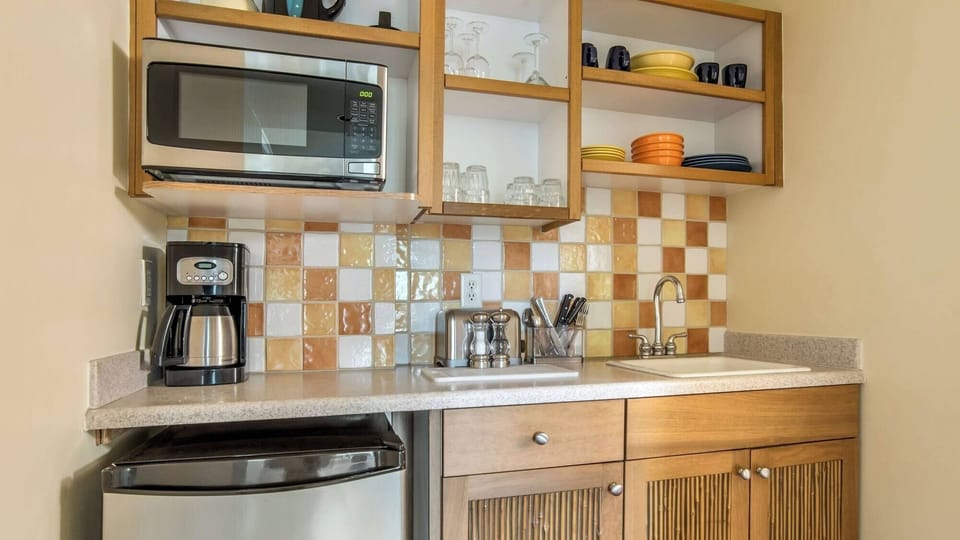 Whip up quick bites with stocked shelves and coffee maker.