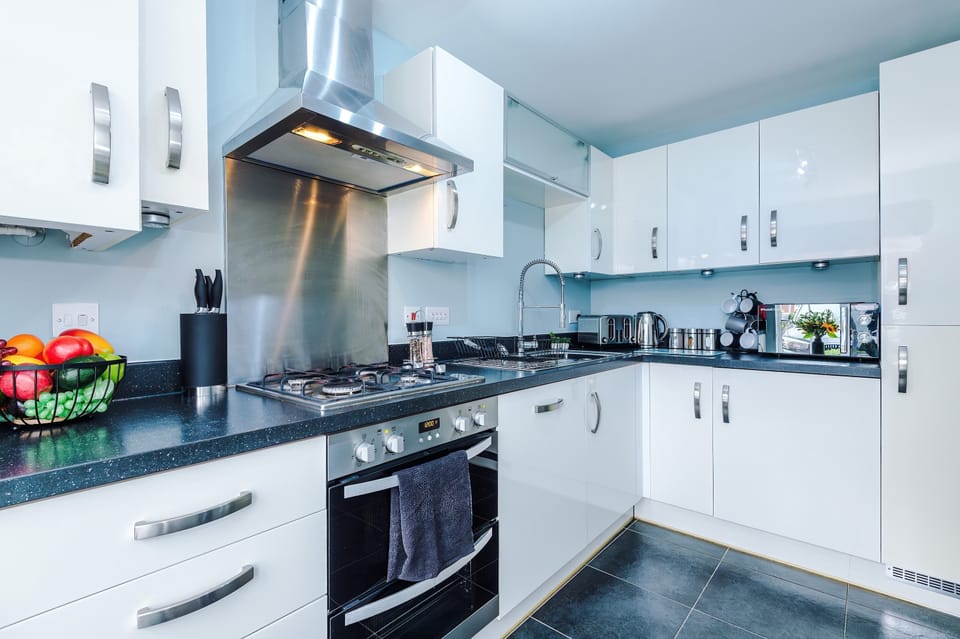 Cook with ease in a stylish kitchen featuring granite counters, stainless steel appliances, and thoughtful touches. A clean, modern design makes meal prep both practical and enjoyable.
