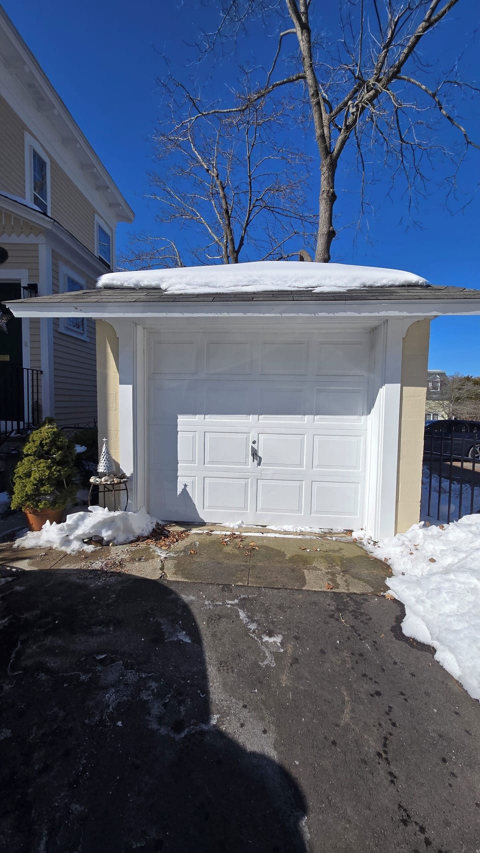 A sunny winter day. Our garage with dedicated parking for one. 