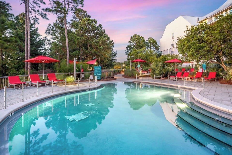 Unwind at the glowing pool, lounge chairs awaiting you.