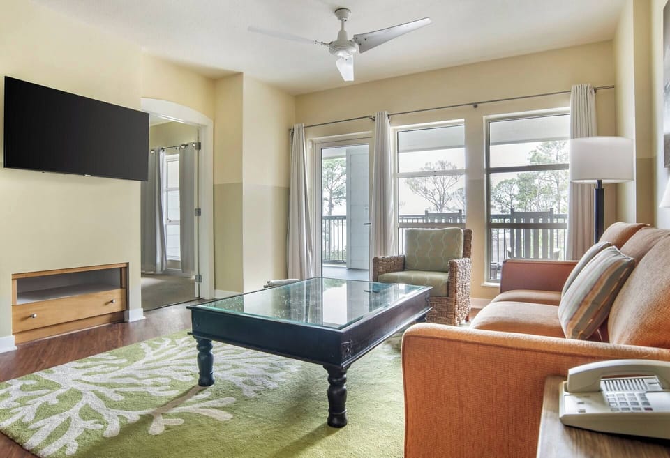 Lounge with morning coffee as balcony views brighten the room.