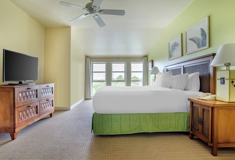 Drift off comfortably in a bright room with leafy views.