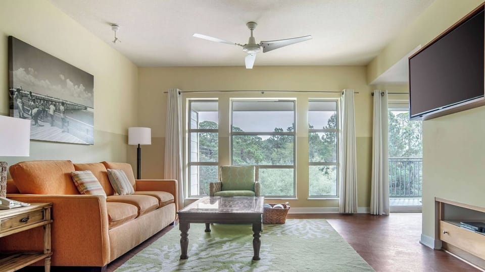 Gather in the airy living room with treetop views.