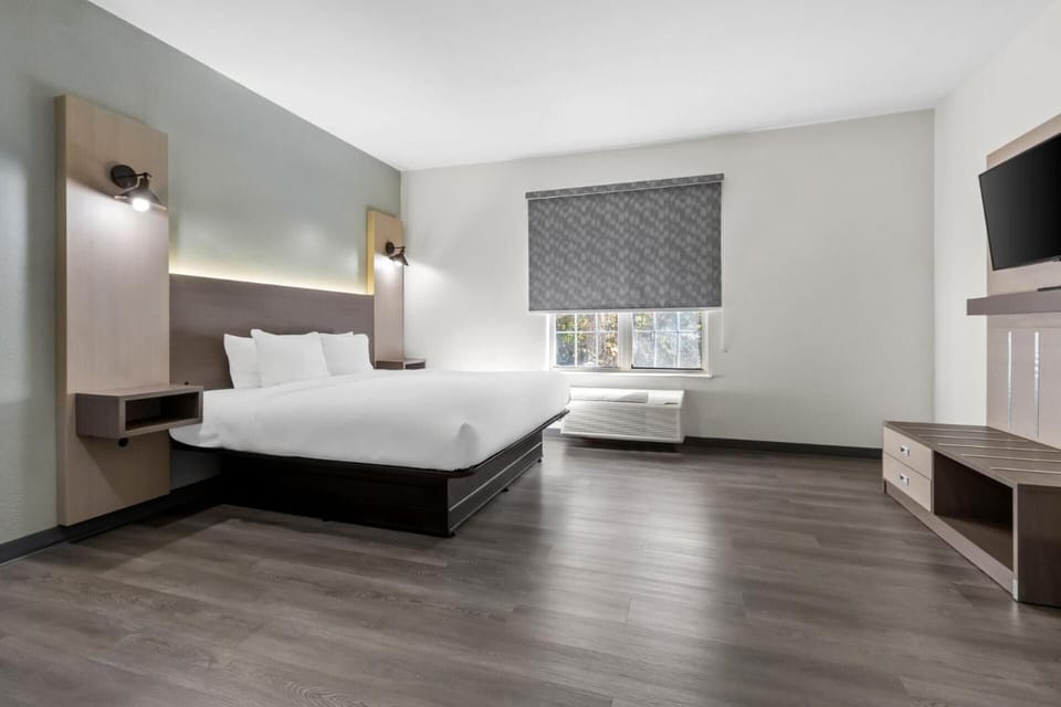 Unwind in a bright, modern room with plush bedding.