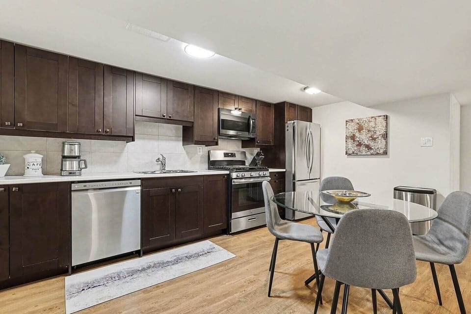 Prepare delicious home-cooked meals in this sleek, modern kitchen featuring stainless steel appliances and ample counter space in Ottawa.