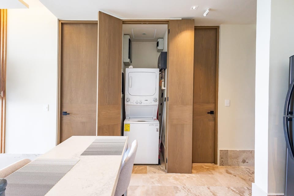 Bright laundry nook with stacked washer and dryer for convenience