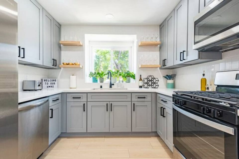 Kitchen fully stocked with high end appliances and kitchen utensils