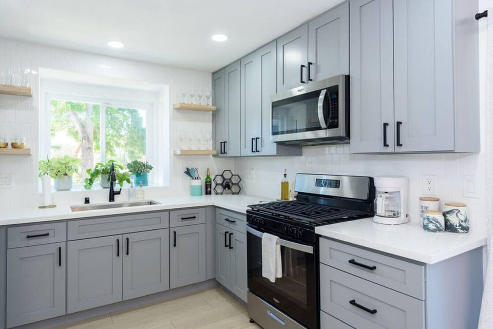 Kitchen fully stocked with high end appliances and kitchen utensils