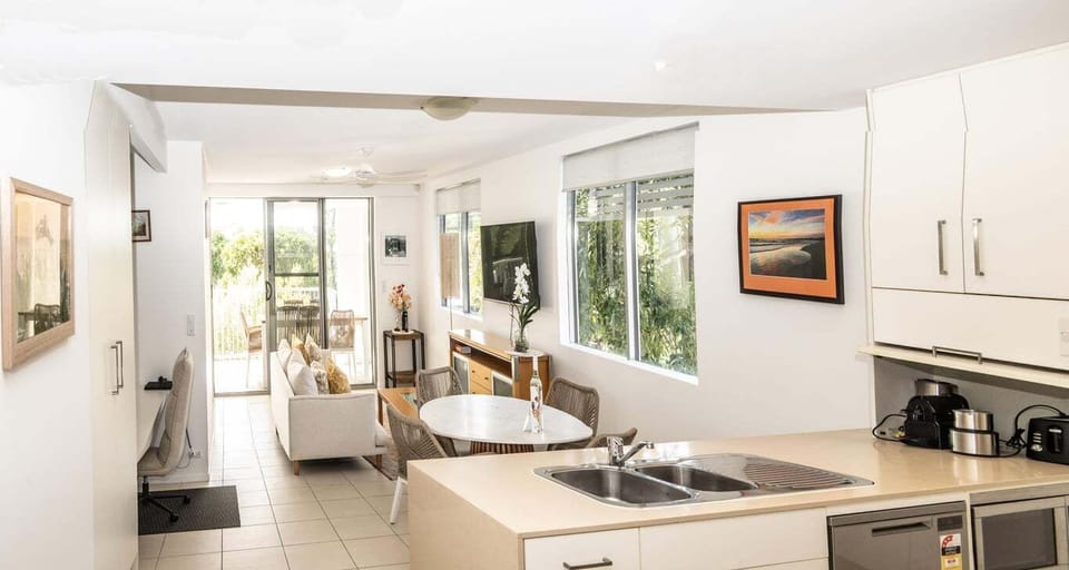 A seamless open-plan layout connecting living, dining, and culinary creations