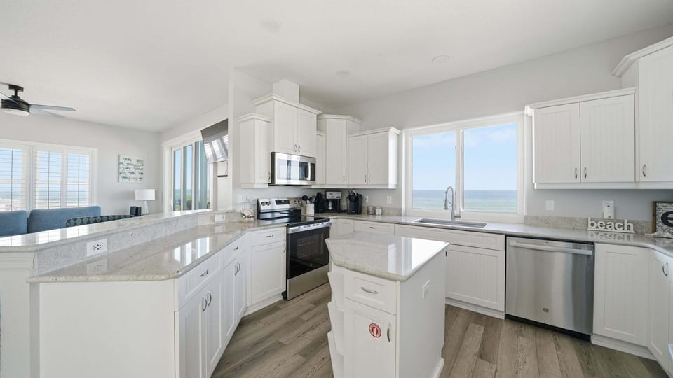 Altogether, the kitchen offers a clean, functional, and scenic space for guests to enjoy during their stay.