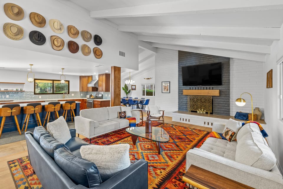 Gather, relax, and make memories in this spacious open-concept living area with a cozy fireplace and stylish mid-century design.