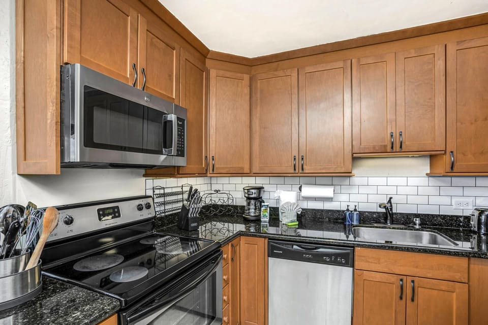 Golden cabinets meet bold stone counters in a space where morning coffee feels like a five-star island ritual    KS-815