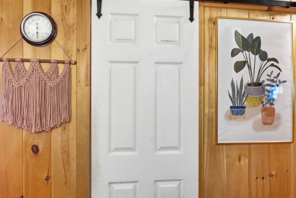 Rustic charm meets smart design. A space-saving, sliding barn-style door opens to the modern bathroom. This thoughtful detail keeps the studio feeling open and airy while maintaining complete privacy in your cozy Maine outpost.