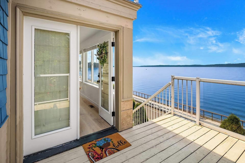 Step into paradise with this sun-filled porch, offering seamless indoor-outdoor living by the water.
