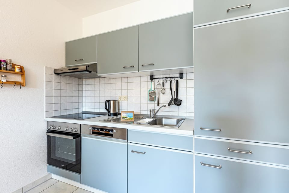 Modern kitchen with stove and refrigerator