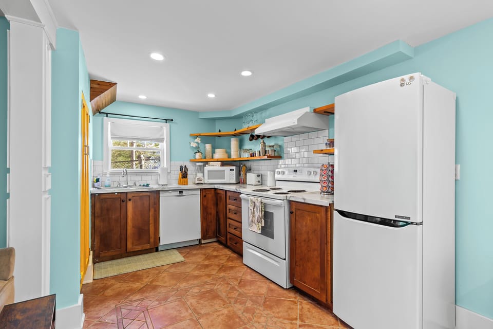Fully equipped kitchen with modern appliances & open shelving