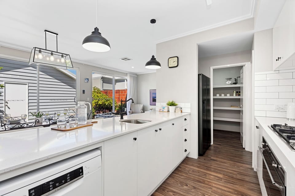 Our kitchen includes a walk-in pantry with plenty of shelving, a full-sized refrigerator, and a gas cooktop to make you feel right at home.