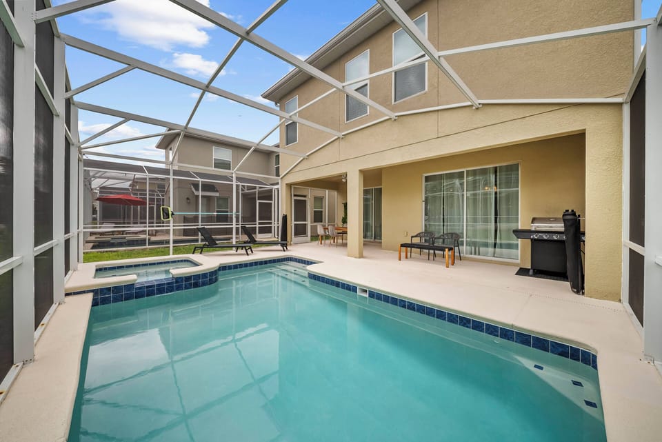 Step outside to the inviting screened pool area, where you can relax on stylish lounge chairs amid beautiful landscaping. The refreshing waters invite you for a swim, with easy access to the spacious interior through sliding.