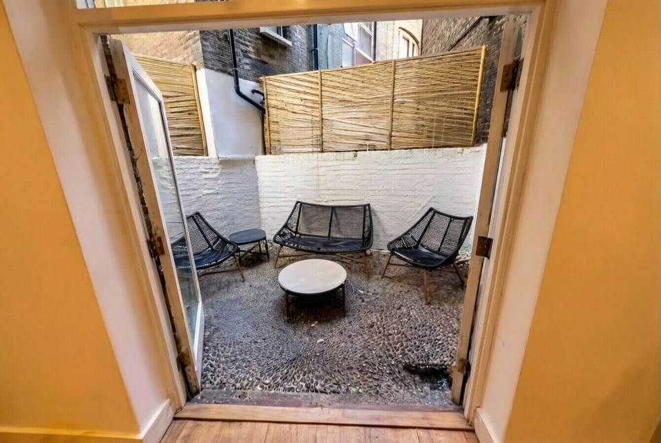 Step through the French doors to reach the peaceful pebble courtyard seating area.
