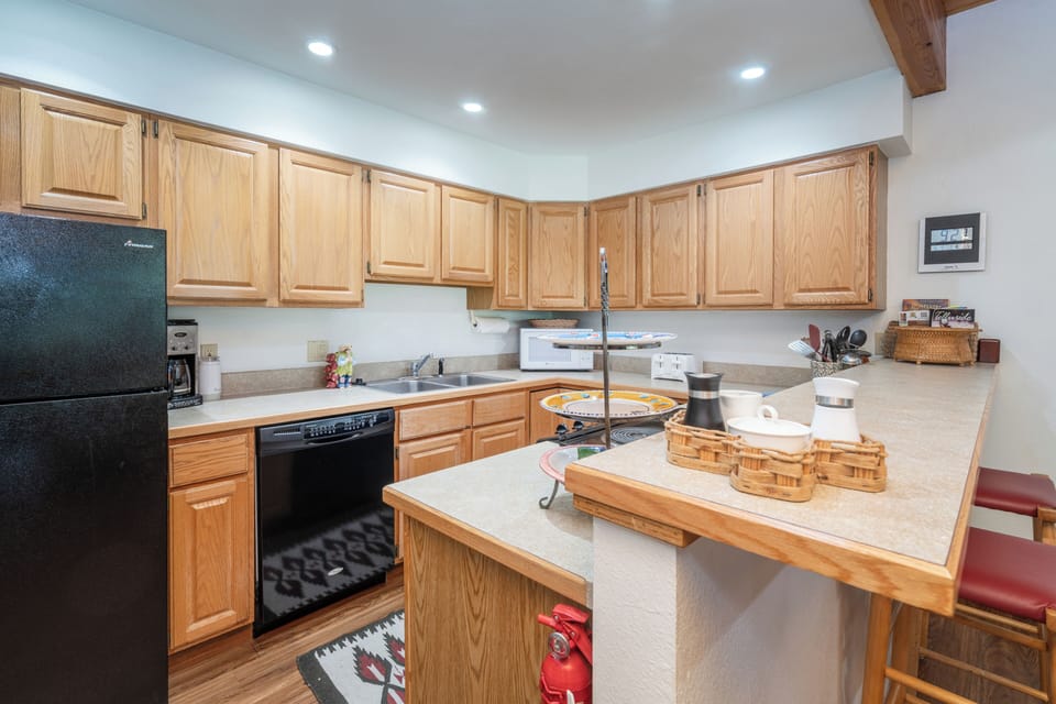 Your fully equipped kitchen features warm oak cabinetry, modern appliances, and a spacious center island—perfect for preparing meals and gathering together during your stay.