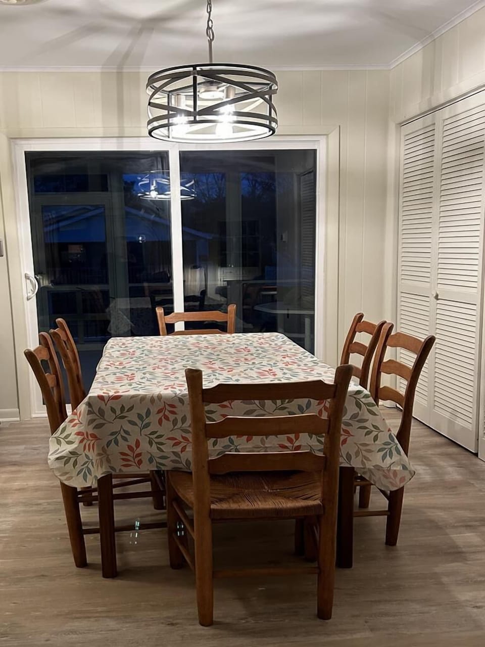 Gather around the spacious dining table where shared meals and laughter await, illuminated by soft evening light.
