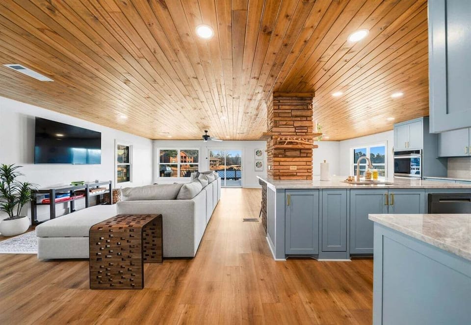 Step inside to a bright, open living area with soaring wood ceilings, comfortable seating, and a spacious layout designed for relaxing together after a day on the lake.