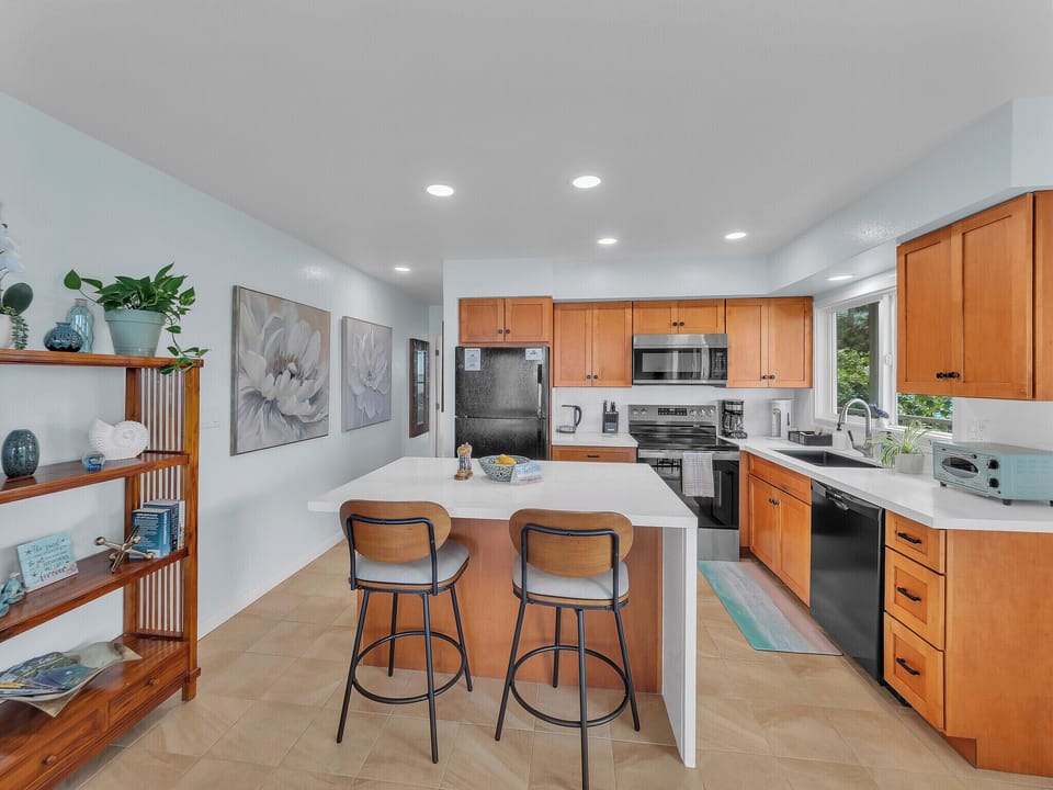 Updated kitchen with new counters, lighting, sink, faucet, decor, bar stools 