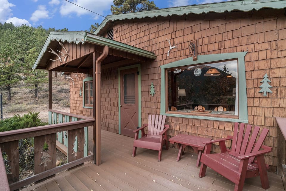 Cabin porch with mountain views and Adirondack chairs
