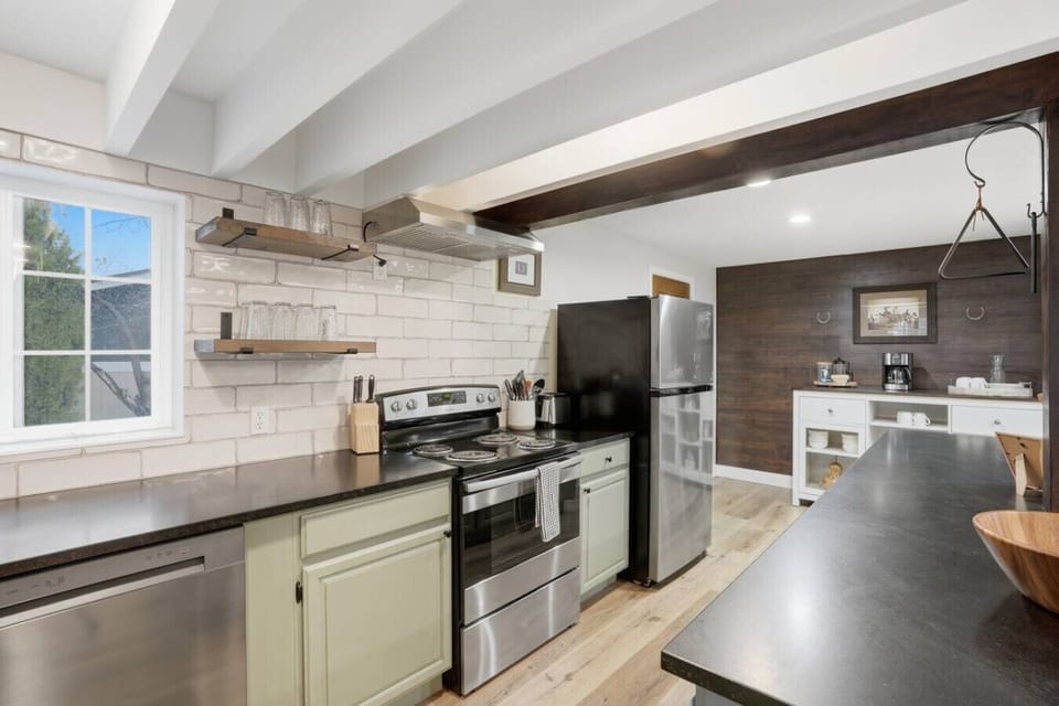 Fully equipped kitchen with stainless steel appliances and ample counter space