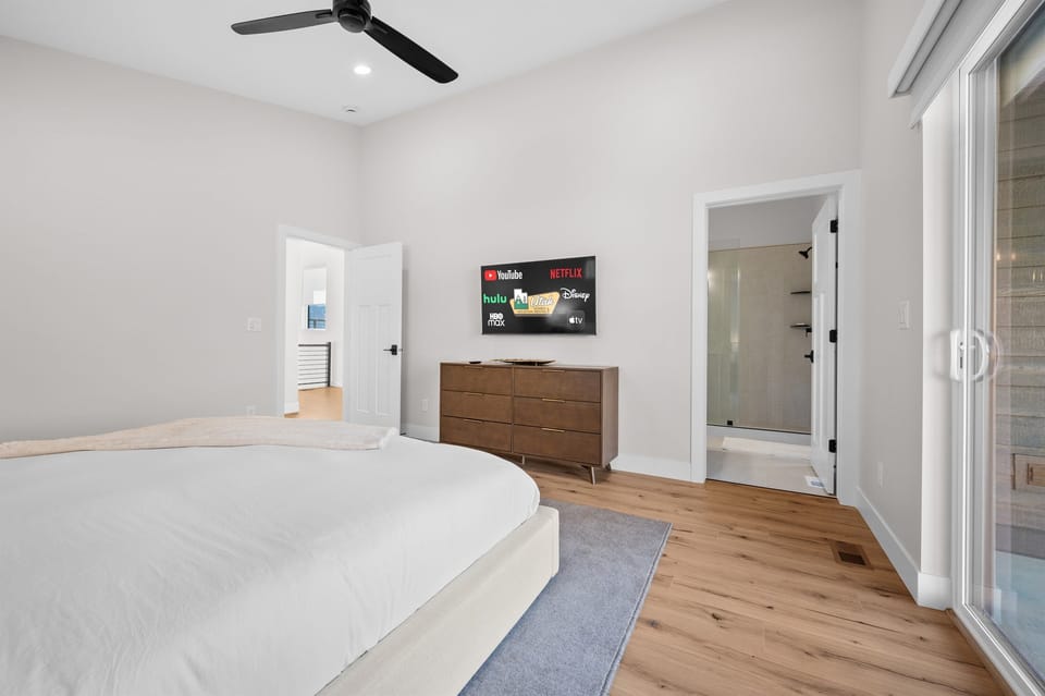 Unwind in the luxurious Primary Bedroom with King bed, Smart TV, and spa-like ensuite bath.