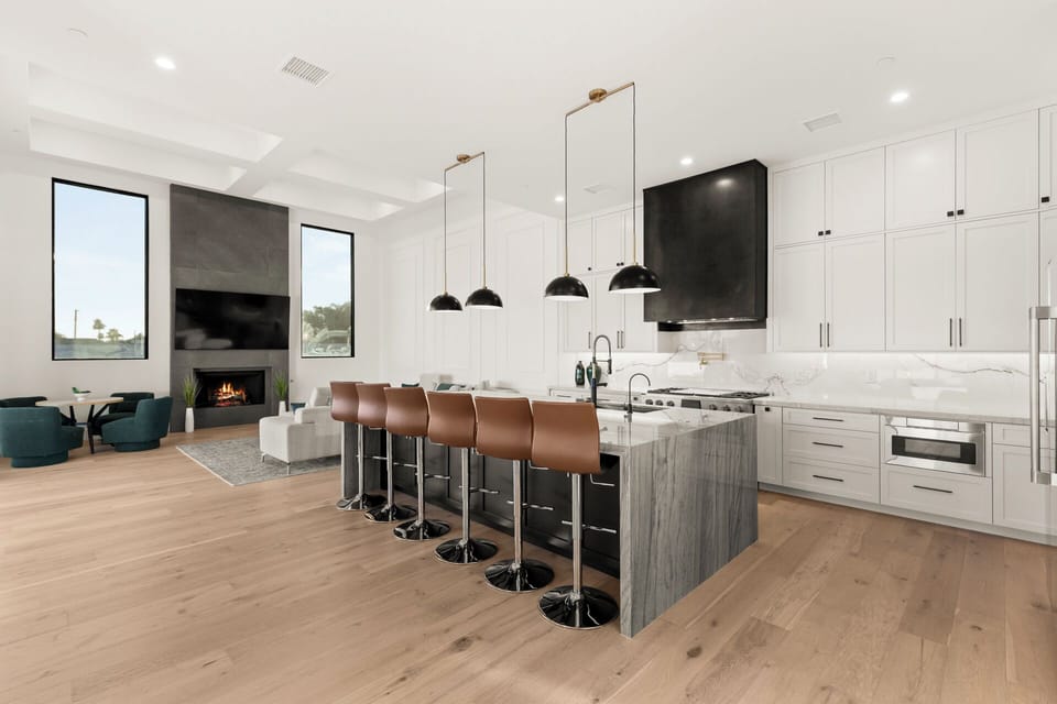 Chef’s kitchen with high-end appliances and marble waterfall island.