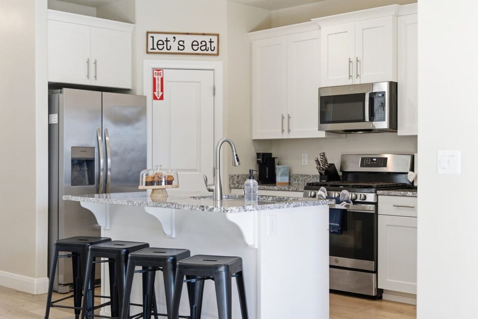 Kitchen: Modern space to whip up culinary delights with sleek appliances and fun bar seating!