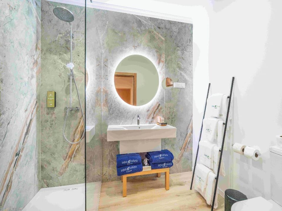 Indulge in a spa-like vanity with glowing mirror light.