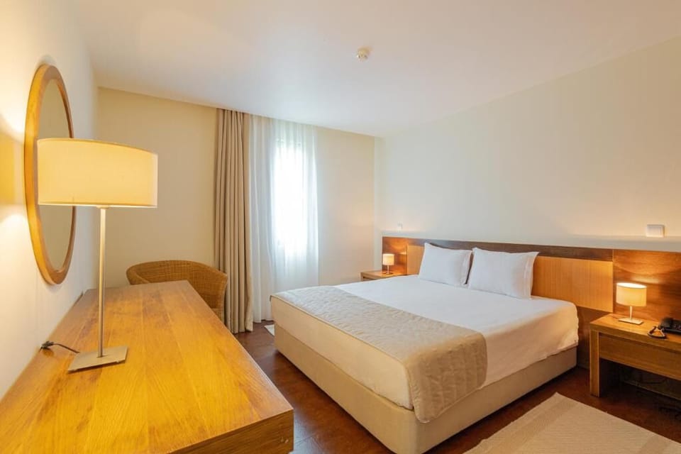 Unwind in a serene bedroom with crisp linens and warm light.