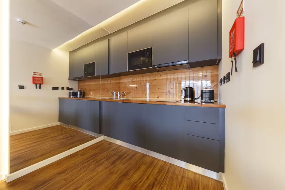 Cook effortlessly in the sleek kitchen with warm wood accents.