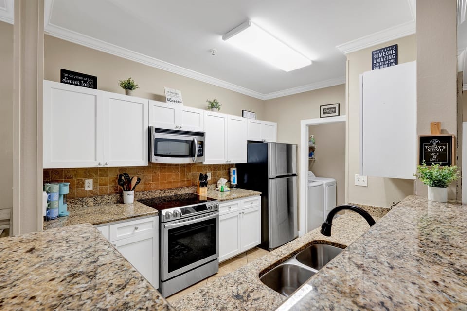 Kitchen with granite tops, stainless appliances and it is fully stocked with everything you need to prepare your meals 