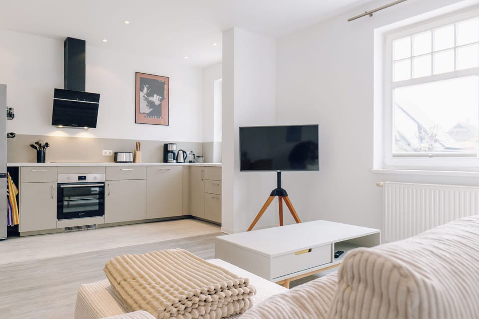 Modern kitchen with appliances and TV