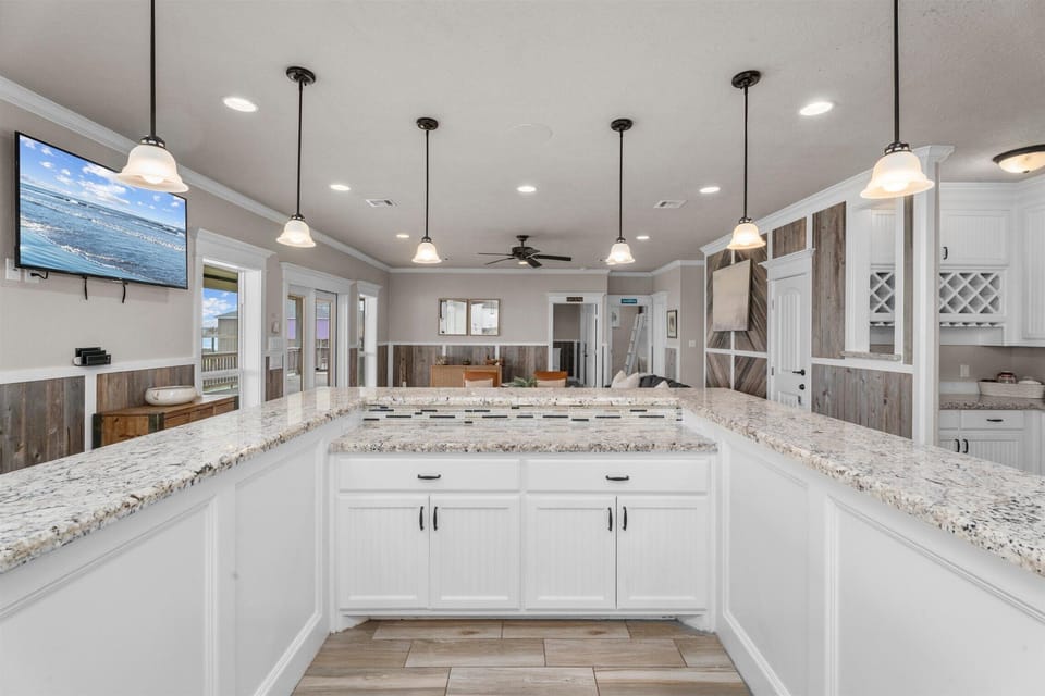 Bright kitchen workspace with ample counter space and cabinetry