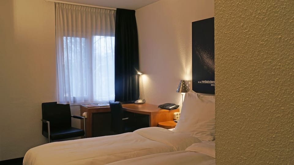 Relax at night with soft lighting and a quiet corner desk.
