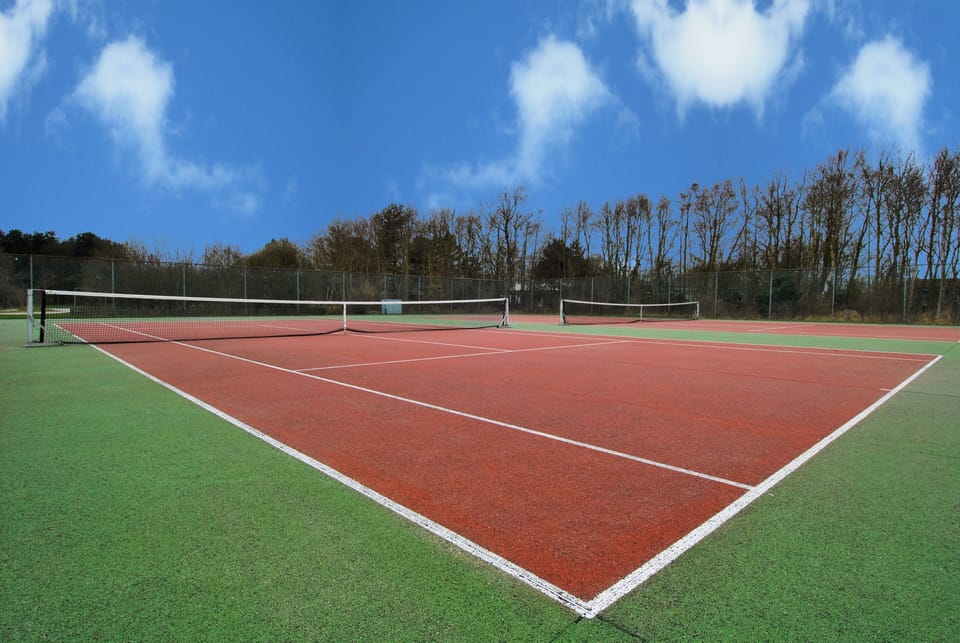 Challenge friends to a match on the private tennis court.