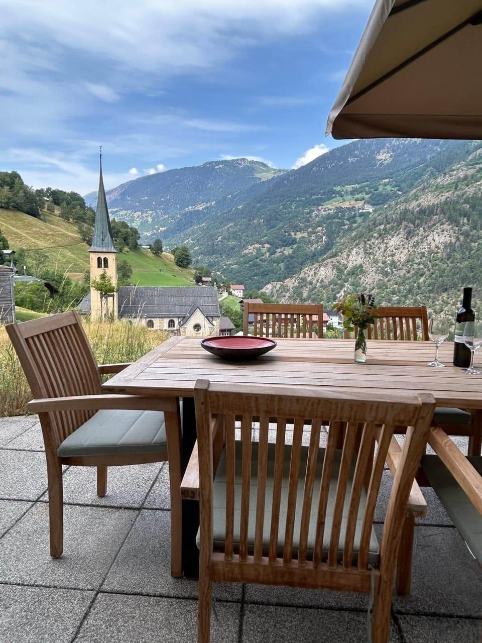 Outdoor dining with views across the valley and village church
